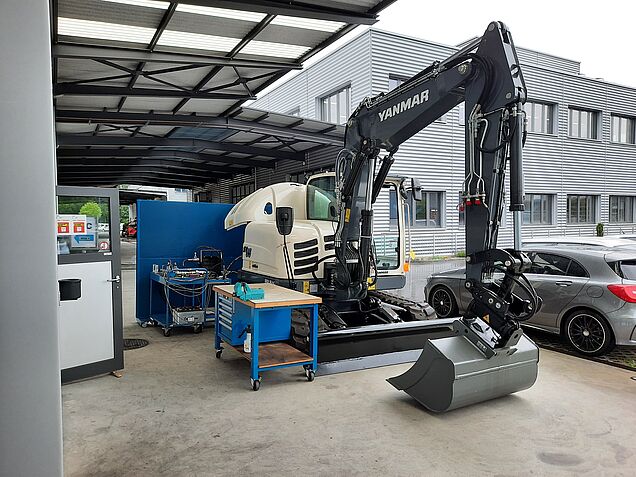 Prüfungssituation im Bereich «Facharbeiten ausführen Motoren» mit einem Bagger Yanmar.